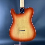 Electric guitar with a sunburst finish on a blue background