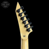 Close-up of a guitar neck with tuning pegs on a black background, featuring the ESP brand.
