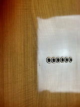 Row of small round objects on a textured surface