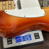 Guitar on a digital scale displaying weight