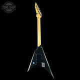 Black electric guitar with gold neck on a black background, featuring 'Tone Shop' logo.