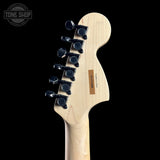 Guitar headstock with tuning pegs on a black background, featuring 'Tone Shop' branding.