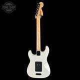 White electric guitar with a black pickguard on a white background, featuring 'Tone Shop' logo.