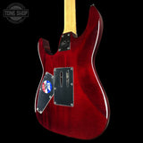 Red electric guitar with a black pickguard on a black background, featuring 'Tone Shop' branding.