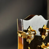 Close-up of a guitar's tuning pegs with a dark background