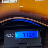 Used PRS SE DGT Sunburst on scale displaying weight.