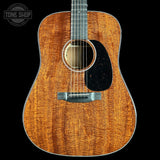 Acoustic guitar with a visible brand logo in the corner