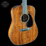 Acoustic guitar with a visible brand logo on a black background