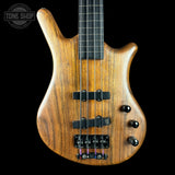 Wooden bass guitar with a black background, featuring the Tone Shop logo.