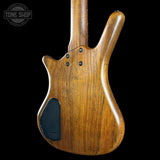 Wooden electric bass guitar on a black background with 'Tone Shop' logo.
