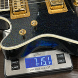 Guitar on a digital scale displaying weight