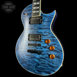 Blue electric guitar with a wavy pattern on a black background, featuring the Tone Shop logo.