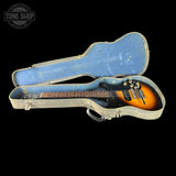 Guitar in a blue case with 'Tone Shop' logo in the corner