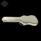Guitar case with 'Tone Shop' logo on a black background
