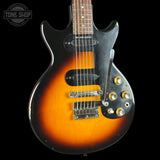 Electric guitar with a sunburst finish on a black background, featuring the 'Tone Shop' logo.