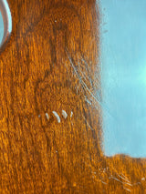 Wooden surface with visible scratches and a blue background