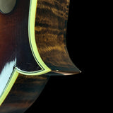 Close-up of a guitar's wooden neck and fretboard on a black background