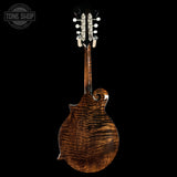 Wooden mandolin with a dark finish on a black background, featuring the Tone Shop logo.