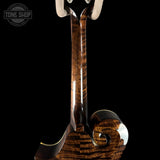 Close-up of a wooden guitar neck and headstock on a black background with 'Tone Shop' logo.