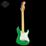 Green electric guitar with a white pickguard on a black background, featuring 'Tone Shop' logo.