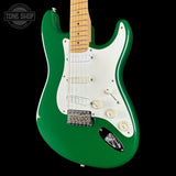 Green electric guitar with a white pickguard on a black background, featuring the Tone Shop logo.