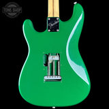 Green electric guitar with a flame pattern on a black background, featuring the Tone Shop logo.