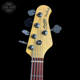Bass guitar headstock with 'Sterling by Music Man' branding on a black background