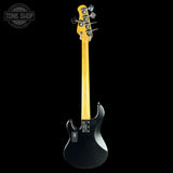 Electric bass guitar with a black body and yellow neck on a white background, featuring 'Tone Shop' branding.