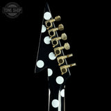 Guitar pickguard with white dots and gold hardware on a black background, featuring 'Tone Shop' logo.