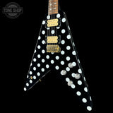 Black electric guitar with white polka dot design on a black background, featuring the Tone Shop logo.