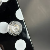 Close-up of a guitar's headstock with tuning pegs on a black and gray background