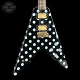 Black electric guitar with white polka dots on a black background, featuring 'Tone Shop' branding.