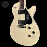 Beige electric guitar with a 'Tone Shop' logo in the corner