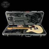 Electric guitar in a hard-shell case with 'Tone Shop' logo.