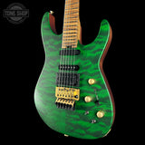 Green electric guitar with a black background