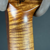 Close-up of a wooden object with 'Heritage' branding on a gray background