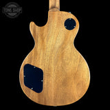 Wooden guitar body with a 'Tone Shop' logo in the corner