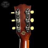 Gibson guitar headstock with brand logo on a black background