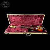 Electric bass guitar in an open case with a Tone Shop logo.