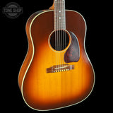 Acoustic guitar with a sunburst finish on a black background, featuring the Tone Shop logo.