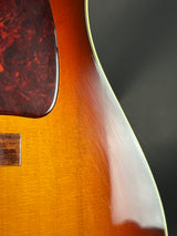 Close-up of a guitar's body with a dark background