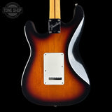 Fender electric guitar body in a classic sunburst finish, showing the transition from amber-orange to black, with a white pickguard and maple neck visible against a black background.