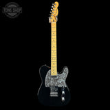 A black Fender Telecaster electric guitar with a glossy black finish, a natural maple neck, and a silver glitter pickguard, shown against a solid black background with a Tone Shop watermark in the top left corner.