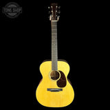 Acoustic guitar with a visible brand logo on a black background