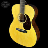Acoustic guitar with a visible brand logo on a black background