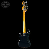 A double-cutaway electric bass guitar shown from the back, featuring a glossy black body and a bright yellow maple neck, photographed against a solid black background.