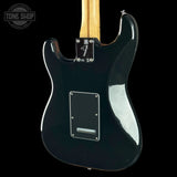 Rear view of a black electric guitar with a maple neck, shown against a solid black background. A Tone Shop watermark is visible in the top-left corner.