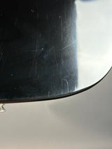 Scratched black surface with a metallic edge on a gray background