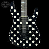 A black electric guitar with a bold white polka-dot pattern, shown from the front against a solid black background. The brand 'Tone Shop' is visible as a watermark in the top-left corner.