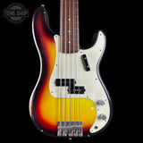 A classic bass guitar with a sunburst finish transitioning from black to orange and yellow, featuring a white pickguard and chrome hardware, shown against a black background with a Tone Shop watermark.